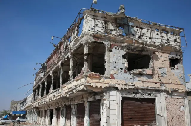 A building damaged during clashes between military forces loyal to Libya"s eastern government and the Shura Council of Libyan Revolutionaries, an alliance of former anti-Gaddafi rebels who have joined forces with the Islamist group Ansar al-Sharia, is seen in Benghaz