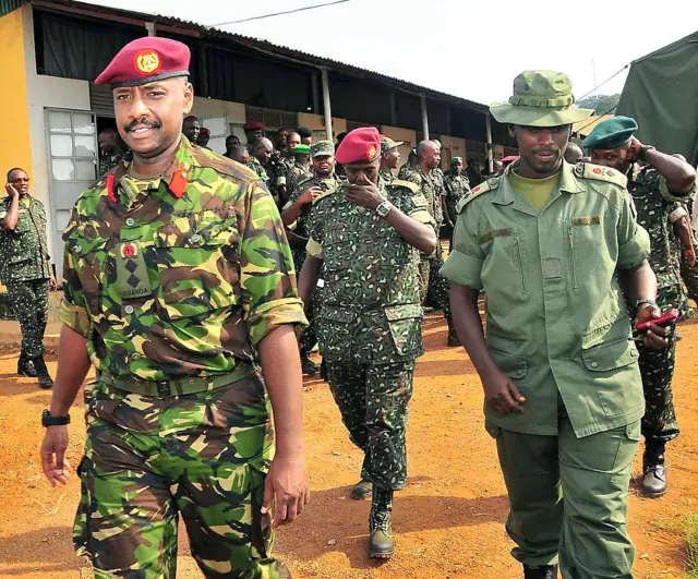 his photo taken on August 27, 2012, shows Brigadier Muhoozi Kainerugaba (L), new commander of the Ugandan Special Forces Command, at the Sera Kasenyi training centre for Special Forces in Kampala on August 16, 2012