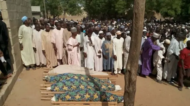 Mourners gather around body