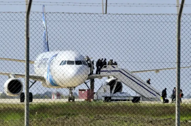 Passengers evacuate a hijacked EgyptAir Airbus 320 plane at Larnaca airport, Cyprus, March 29, 2016.