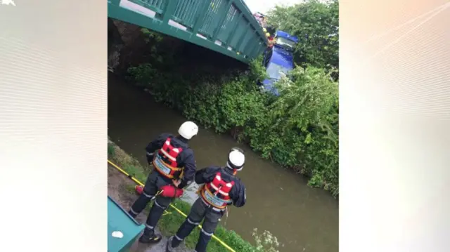 Car hanging over canal