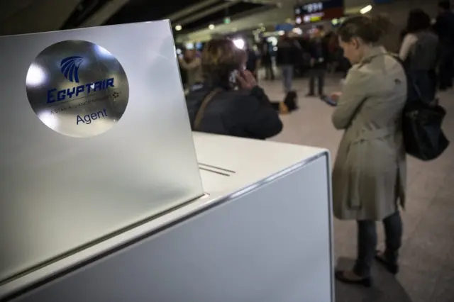 Women waiting at EgyptAir desk at Charles de Gaulle airport