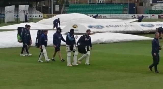 Derbyshire's cricketers ready for their warm up session between the showers at Chelmsford