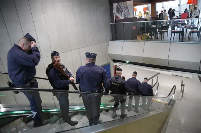 Police officers patrol at Charles de Gaulle airport, outside of Paris