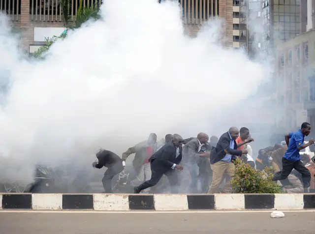 Kenya's opposition politicians and supporters run away from tear gas, on May 9, 2016 in Nairobi