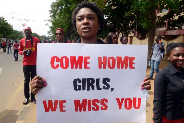 A woman carries placard to press for the release of missing Chibok school girls during a rally by civil society in Lagos on May 5, 2014.