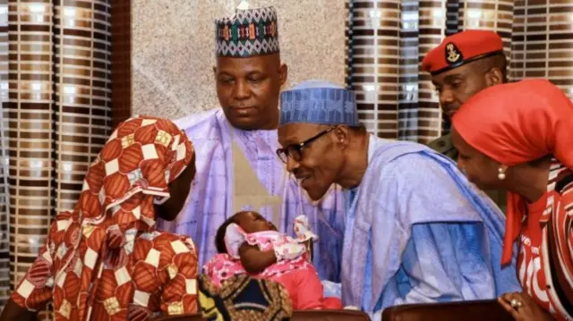 President Buhari meets Amina (L) and her baby