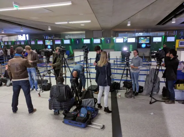 Reporters gather in front of the EgyptAir counter at Charles de Gaulle Airport outside of Paris on Thursday, May 19, 2016.