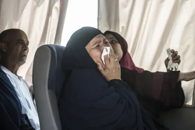 A relative of a passenger who was flying aboard an EgyptAir plane that vanished from radar en route from Paris to Cairo overnight cries as family members are transported by bus to a gathering point at Cairo airport on May 19, 2016.