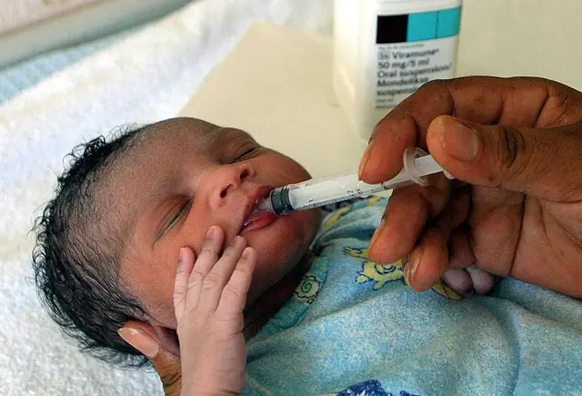 Baby receiving oral medicine