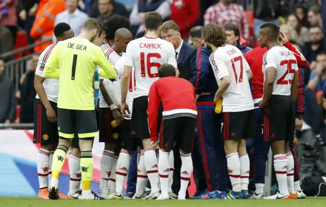 Louis van Gaal talks with their players