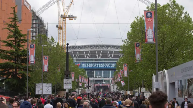 Supporters walk down Wembley way