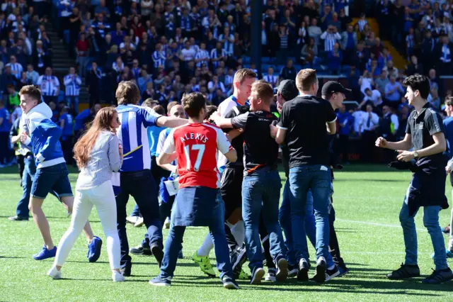 Kilmarnock fans celebrate on the pitch