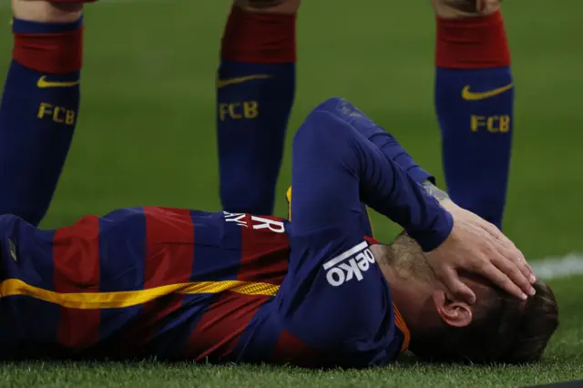 Lionel Messi on the ground injured