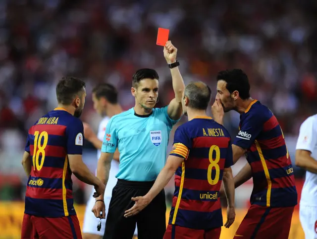 Referee Carlos del Cerro Grande shows the red card