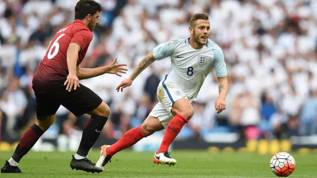 Jack Wilshere runs with possession