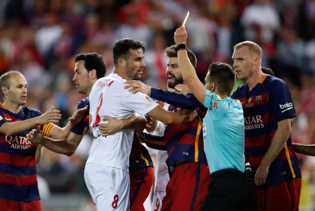 Vicente Iborra is shown a yellow card