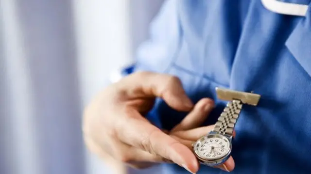 Nurse looking at watch