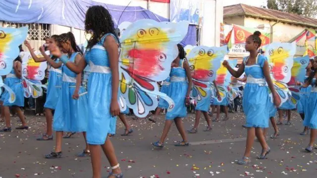 Girls in blue butterfly costumes take part in a parade