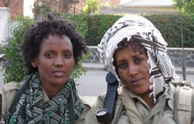 Women dressed as fighters in military fatigues