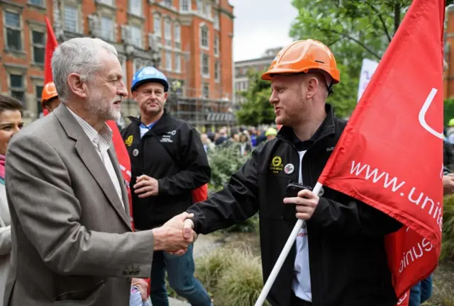 Jeremy Corbyn shakes hands with a steel worker