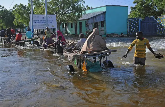 Residents use donkeys to travel through flooded streets in Beledweyne, north of Mogadishu on May 26, 2016.