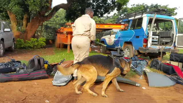 A sniffer dog and policeman outside Kampala's High Court