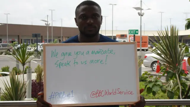 Sign reads: "We gave you a mandate; speak to us more!"