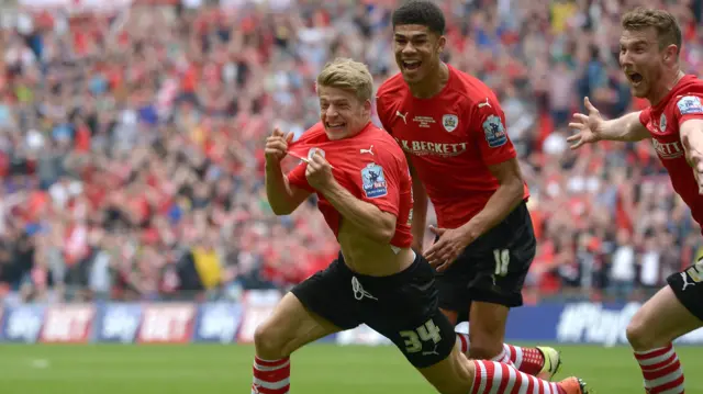 Lloyd Isgrove of Barnsley scores his teams third goal