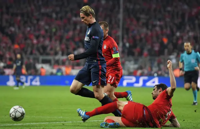 Javi Martinez challenges Fernando Torres for a penalty kick