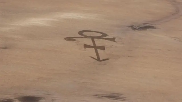 Prince's glyph, plowed into a field