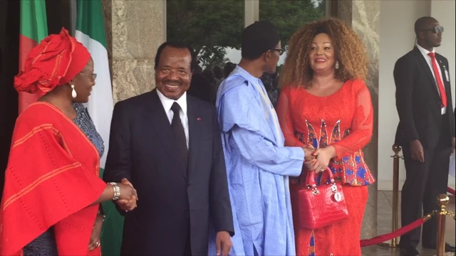 Paul Biya and Chantal Biya being greeted by President Buhari