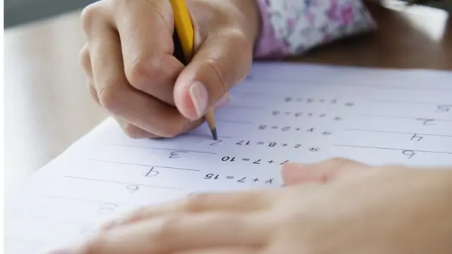 Child filling out test paper