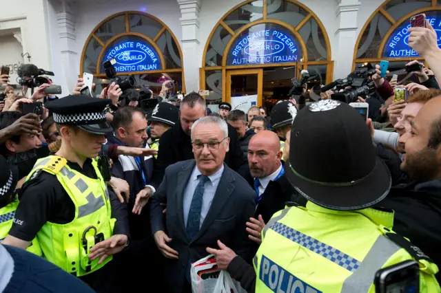 Claduio Ranieri is mobbed outside an Italian restuarant