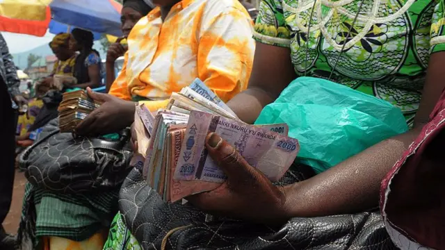 Money changers with wads of cash