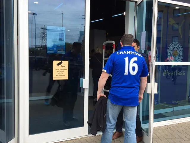 Man wearing Leicester City shirt with 'champions 16" printed on the back