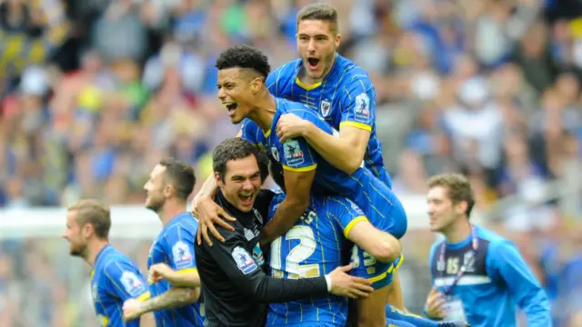 AFC Wimbledon players celebrate at full-time