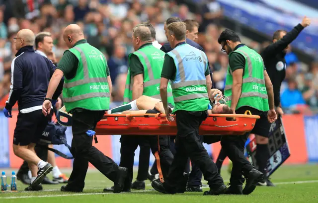 Peter Hartley leaves the field on a stretcher