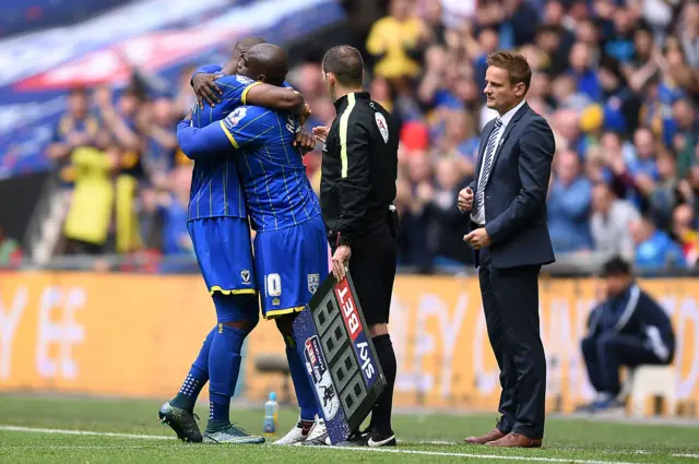 Andy Barcham is replaced by Adebayo Akinfenwa