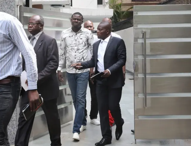 Men walking out of a security gate