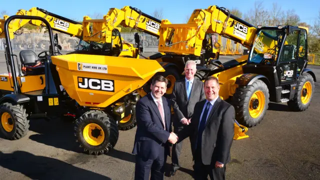JCB UK & Ireland Sales Director Dan Thompstone (left) seals the deal with Plant Hire UK (PHUK) MD Graham Jones. Looking on (centre) is Gunn JCB Sales Director John Dolphin.