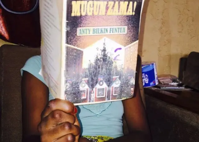 A girl reading a Hausa novel