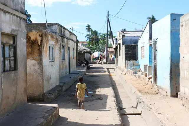 A child walks down a street in the Macuti nighborhood, on June 12, 2015 in Ilha de Mozambique
