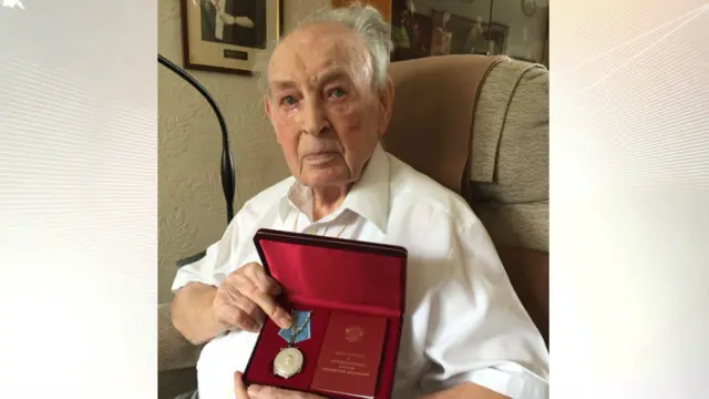 Ronald Gray with the medal