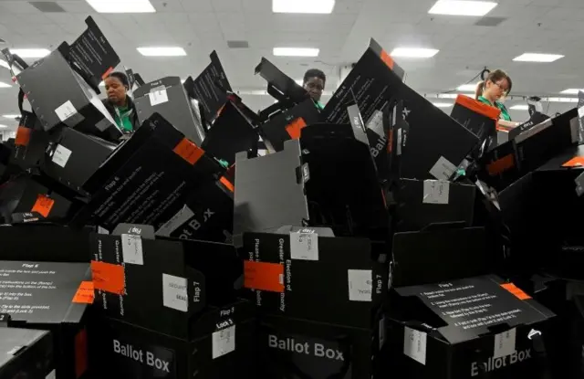 Electoral staff work at a count centre