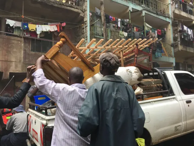 Residents piling goods up on a pick-up truck