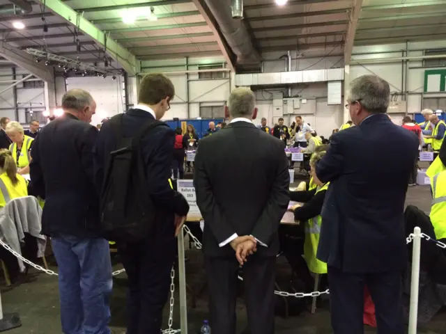 SNP candidate Jim Eadie, hands clasped behind his back, watches the count closely