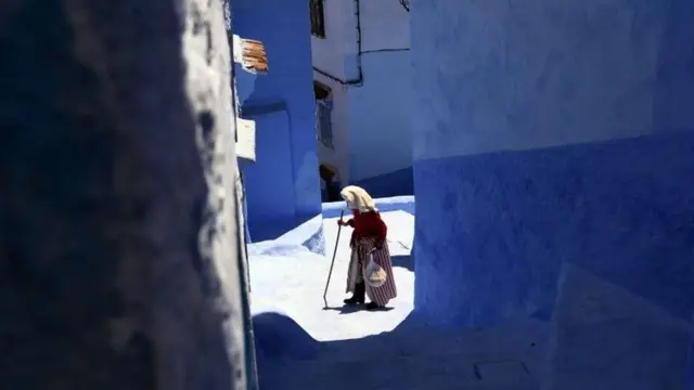 A woman walks along a small alley in Chefchaouen, Morocco, Sunday 1 May 2016