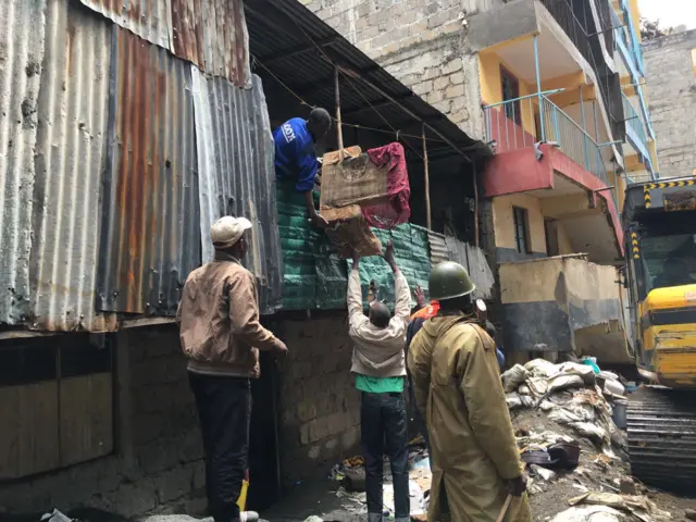 Man carrying out goods from house