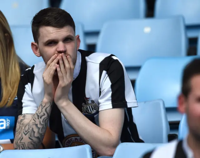 Newcastle United supporter looks dejected